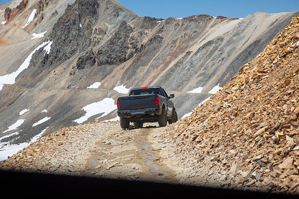 View through window of 2nd vehicle, under blue skies, Utah