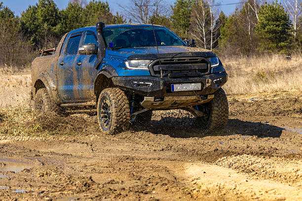 Modified cars for driving in difficult terrain, sorry through mud, water and sand, sports competition during off road car race