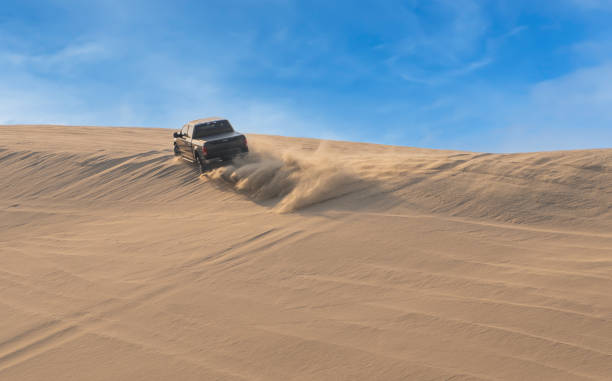 Desert Safari, a black SUV is bashing through the arabian sand dunes in Doha, Qatar