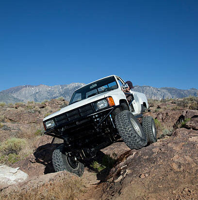 Highly modified mini truck in rough terrain. Sierra Nevada Mountains in the back ground. Click on an image to go to my Old Cars and Hotrods Lightbox.